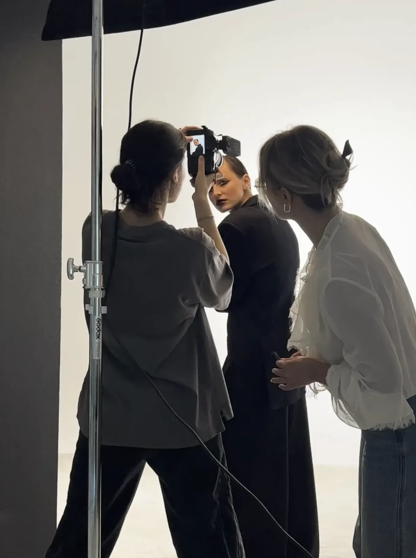 Behind the scenes: photographer and stylist working under a Profoto softbox